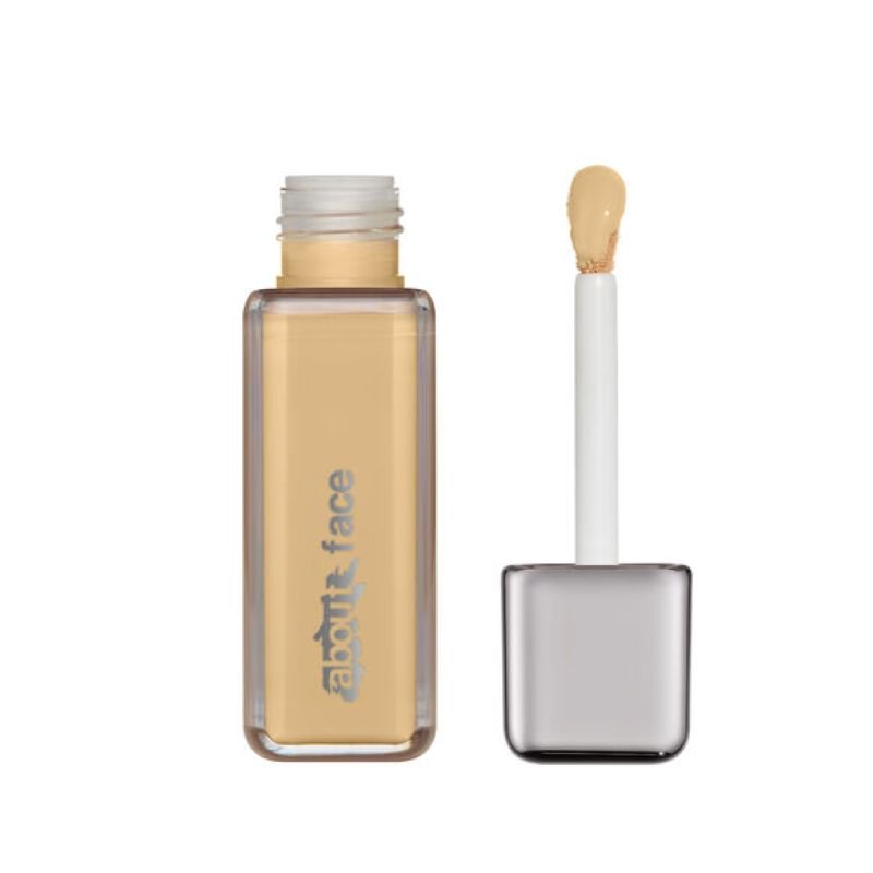 A bottle of About Face foundation in a neutral shade with an applicator
