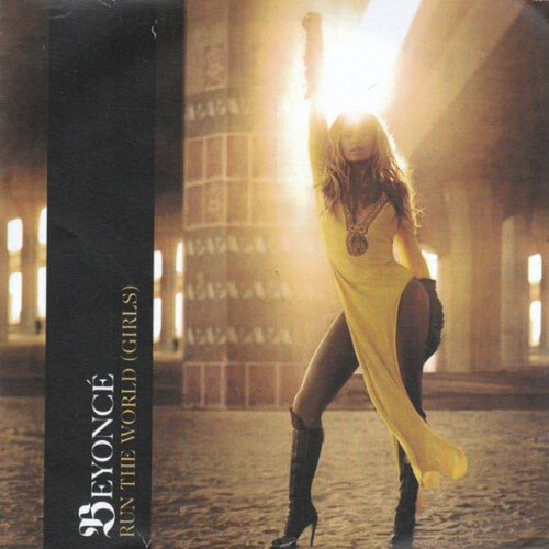 Single cover for Run The World (Girls) by Beyonce. Beyoncé poses confidently in a yellow dress, raising her arm in a powerful stance against a dramatic backdrop