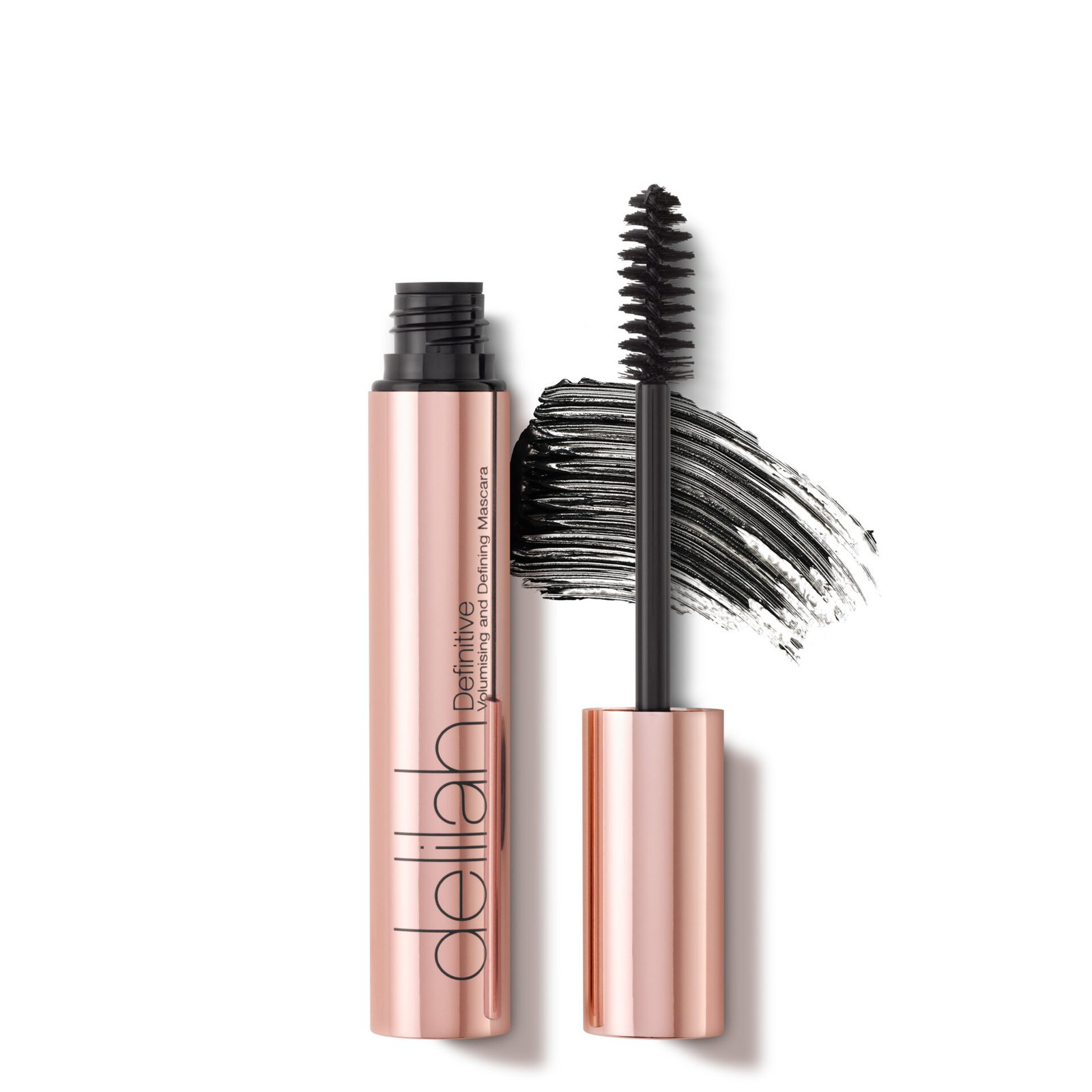 Delilah Cosmetics Definitive Volumizing and Defining Mascara in a rose gold tube with a black brush and a swatch of mascara