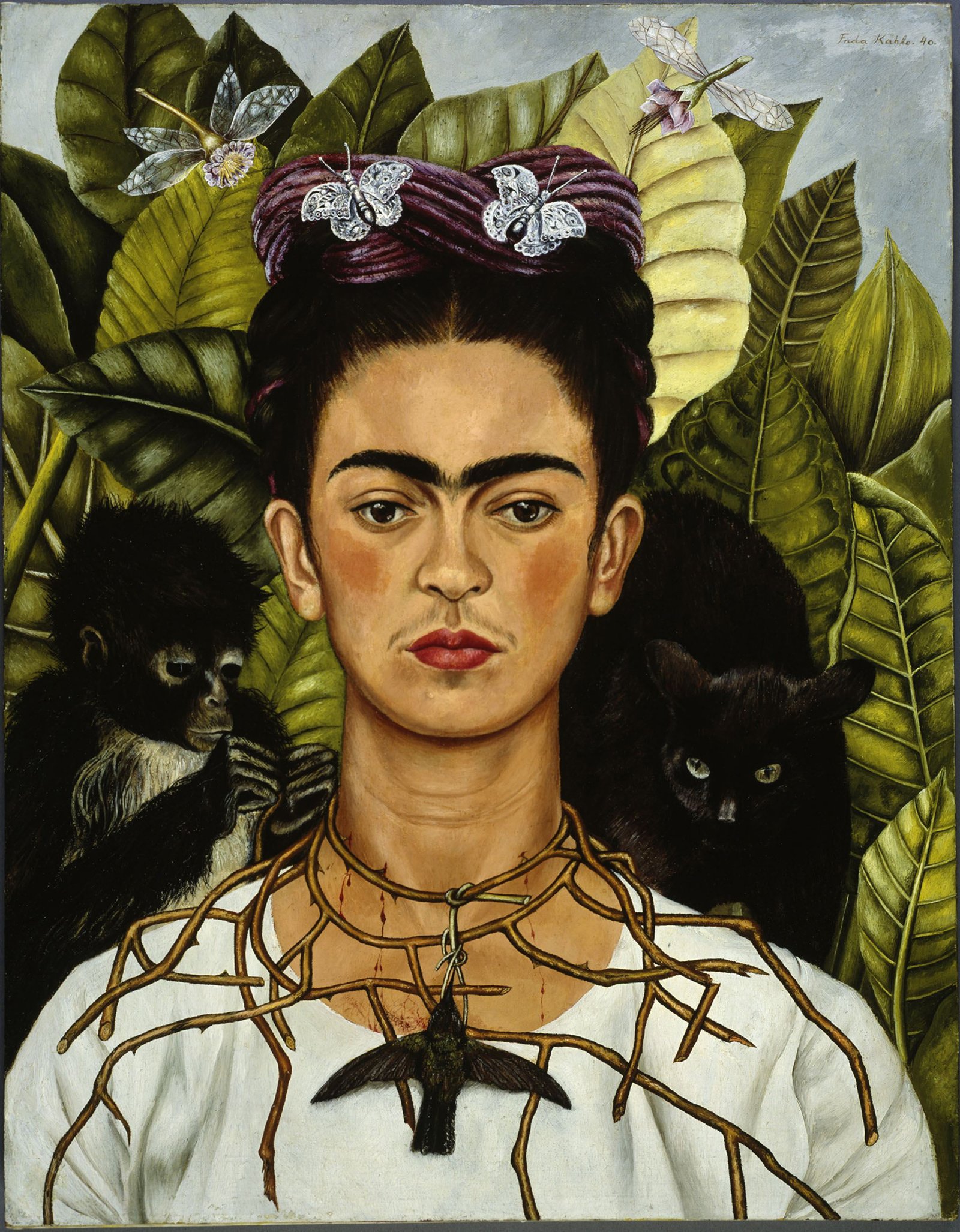 Frida Kahlo in a white dress wearing a necklace of thorns that pricks her neck. A dead hummingbird hangs from the thorns, flanked by a monkey and a black cat against lush tropical foliage.