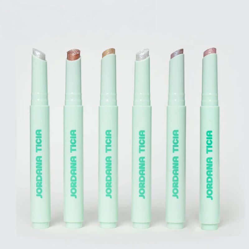 Five Jordana Ticia Gummy Twinkle Sticks in pastel green casing with varying shimmer colours