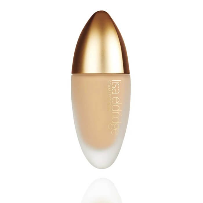 A sleek bottle of foundation with a gold cap and a matte body, labelled 'Lisa Eldridge Seamless Foundation'