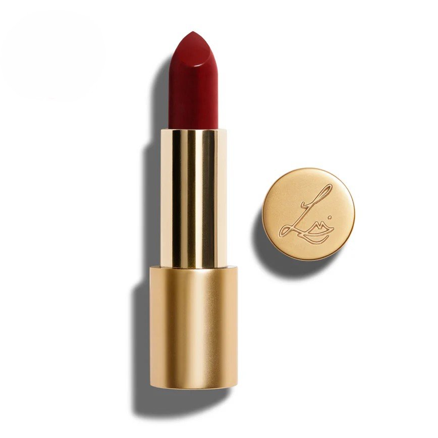 Lisa Eldridge True Velvet red lipstick in a gold tube, displayed with its cap beside it