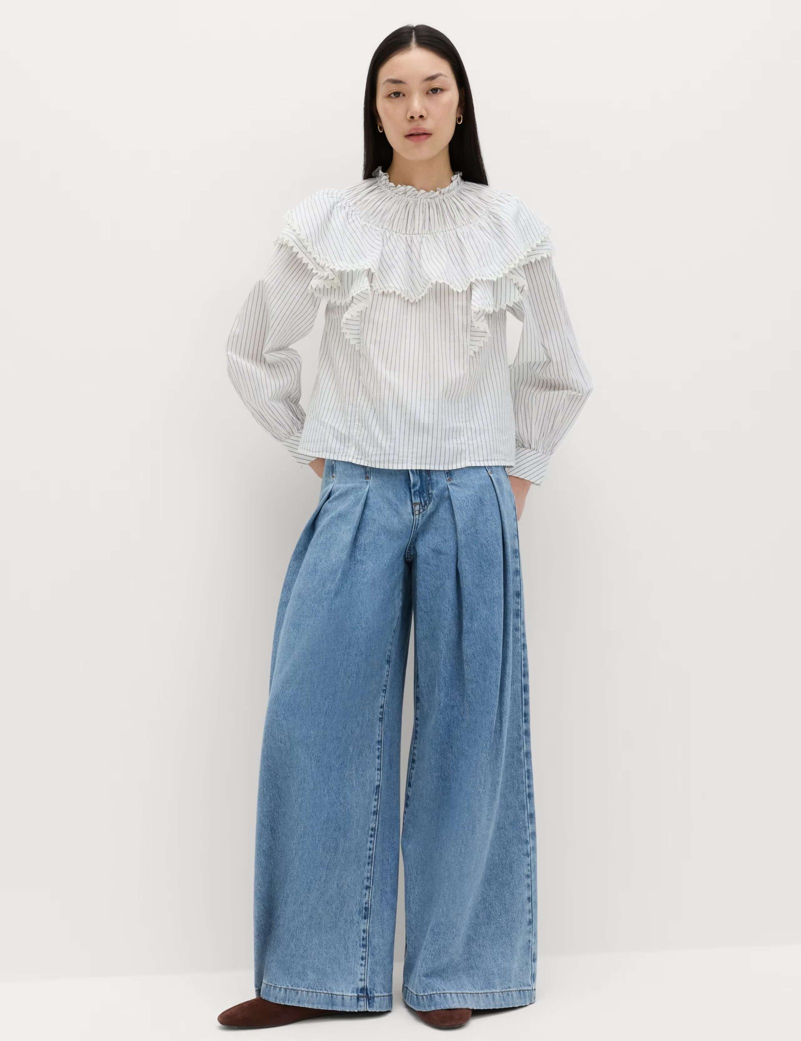 Model wearing M&S pure cotton striped lace detail blouse, a white long-sleeve blouse with vertical stripes, featuring a large, ruffled collar and cuffs