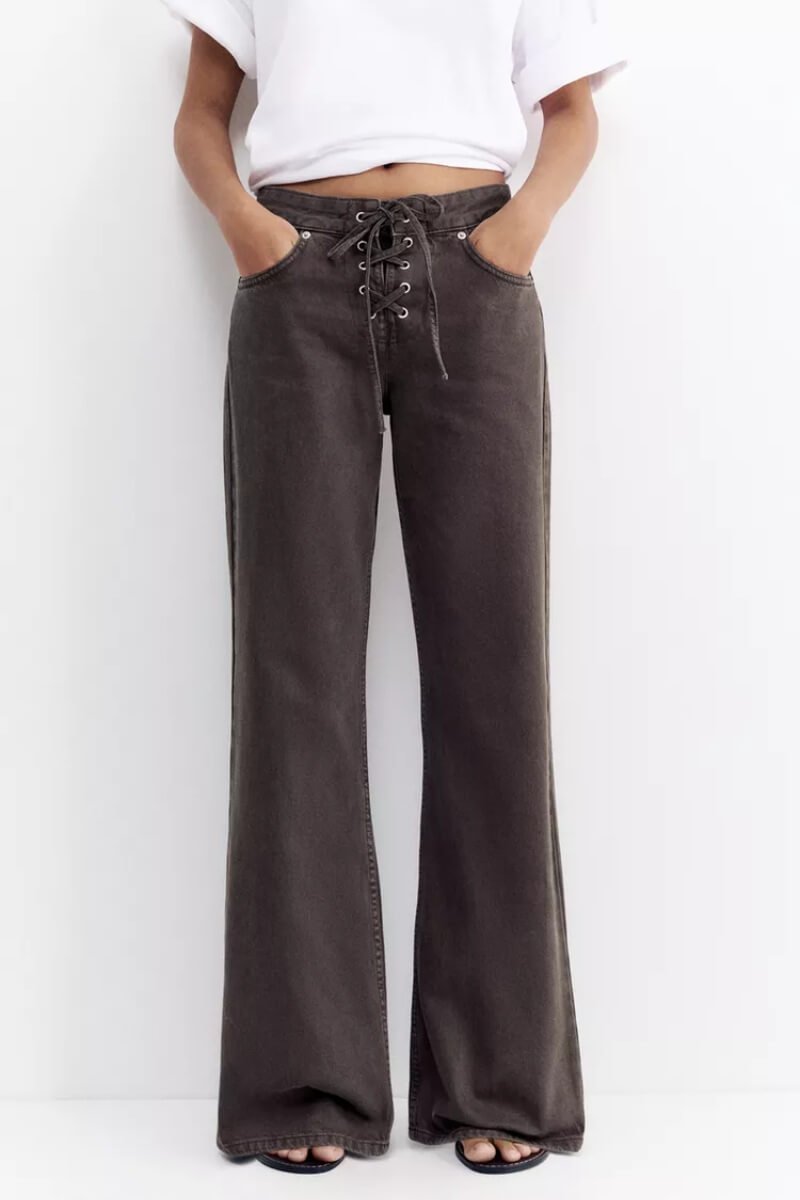 Pull & Bear low-rise corsair jeans in dark grey with a lace-up front and wide flared legs worn with a white top