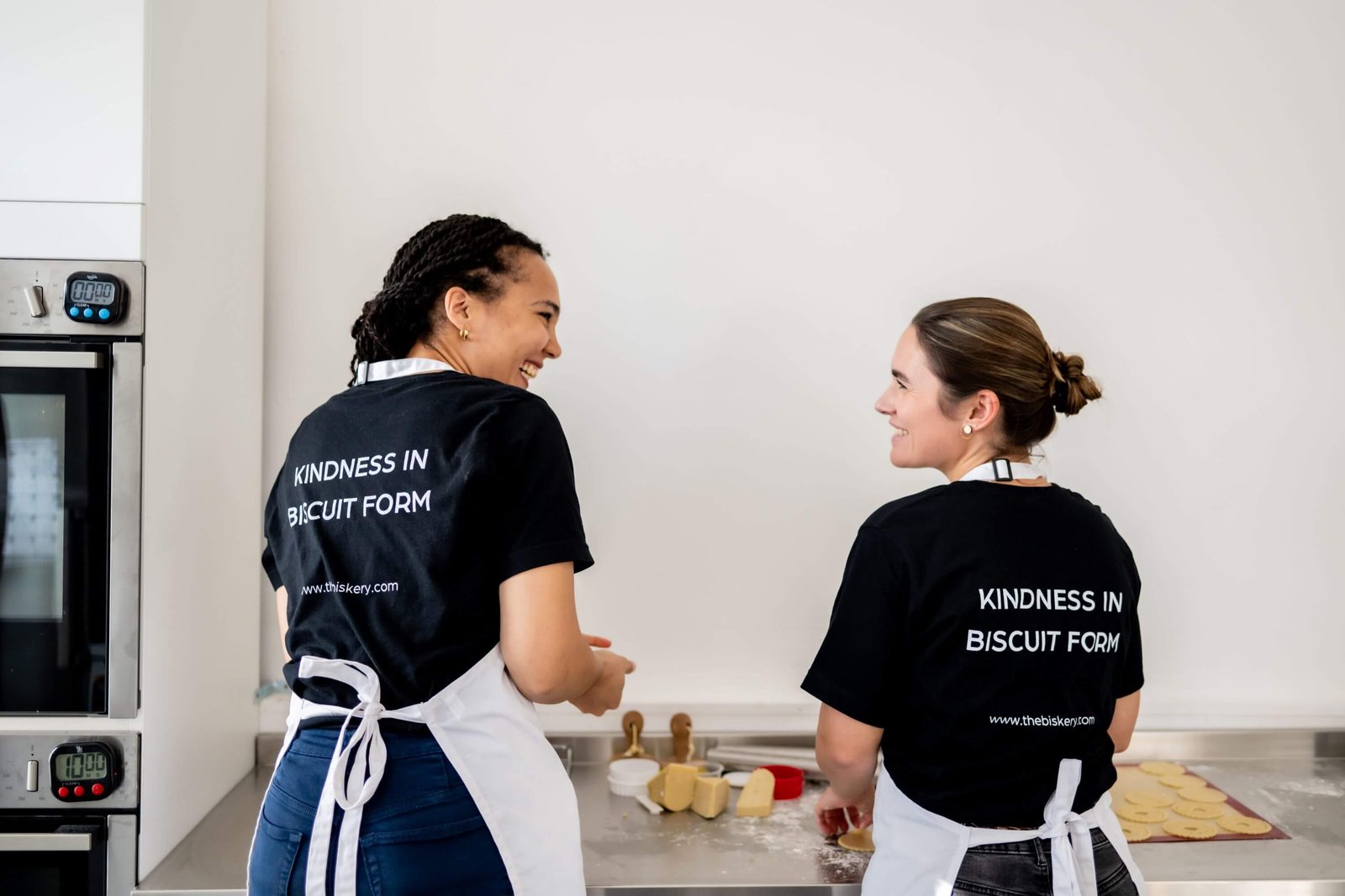 Lisa Shepherd and Saskia Roskam preparing biscuits together at The Biskery bakery in Leeds, showcasing the women-led gifting business built around flexible working and motherhood