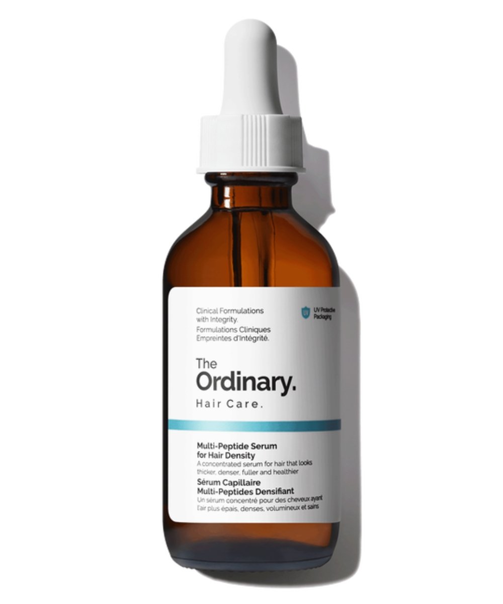Brown glass bottle of The Ordinary Multi-Peptide Serum for hair density with a dropper cap, on a white background
