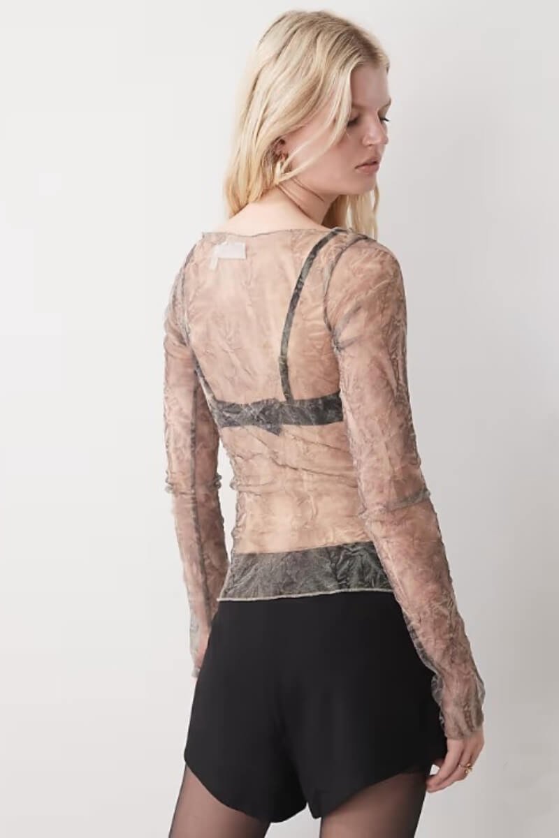 Back view of model wearing Weekday sheer mesh long sleeve top over a black bra