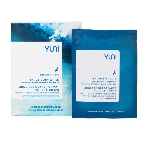 Two packages of YUNI brand large body shower sheets in blue packaging, one open and one closed
